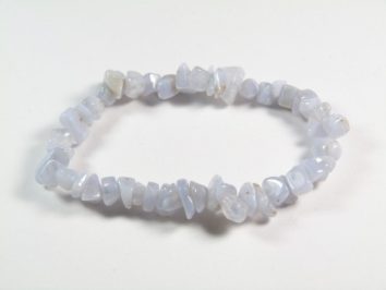 Bransoletka z drobnych, jasnoniebieskich kamieni na elastycznej żyłce na białym tle.