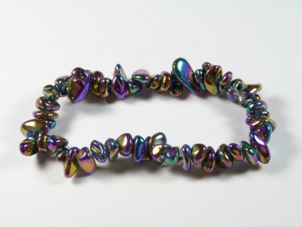Bransoletka z kolorowych, nieregularnych koralików na białym tle.