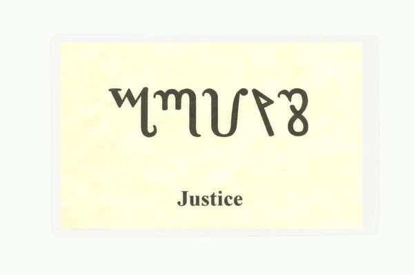 Karta z napisem „Justice” oraz symbolami w obcym alfabecie na żółtym tle.