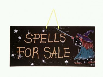 Tabliczka z napisem „Spells for sale” i rysunkiem czarownicy machającej różdżką.