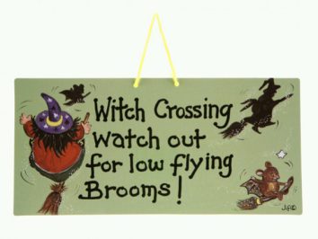 Tabliczka z napisem ostrzegającym przed nisko latającymi miotłami czarownic.