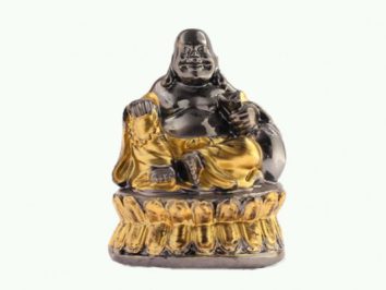 Budda miniaturowy figurka. Czarna i złota figurka siedzącego Buddy uśmiechającego się, ustawiona na ozdobnej podstawie.