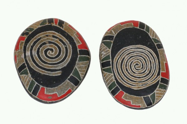 Dwa ozdobne kamienie z kolorowymi spiralnymi wzorami na jasnym tle.