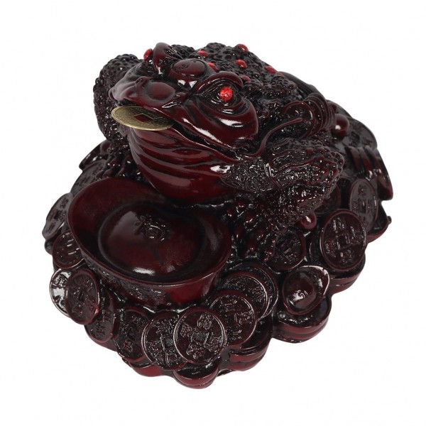 Figurka chińskiej żaby trzymającej monetę w pysku, siedzącej na stosie monet i złota.