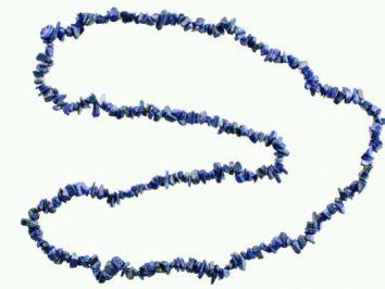 Naszyjnik z niebieskich, nieregularnych kamieni na białym tle.