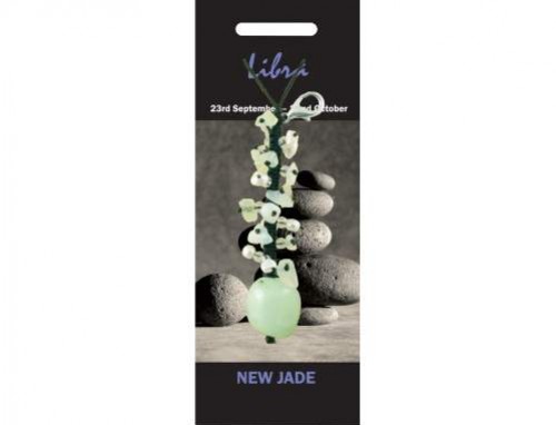 Wisiorek z jadeitu na tle ułożonych kamieni, podpis: "Libra, New Jade".