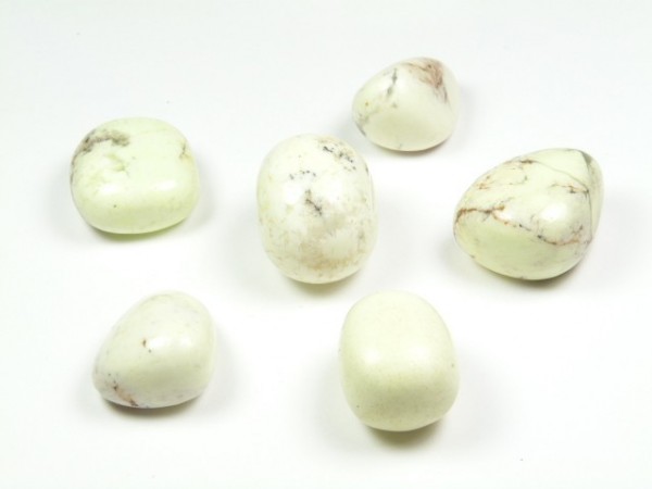 Chryzopraz lemon kamień gładzony szlifowany polerowany bębnowany otoczak. Sześć jasnych, gładkich kamieni leży na białym tle.