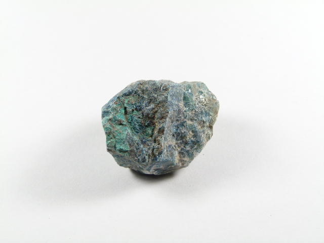 Niebiesko-zielony minerał w surowej formie na białym tle.