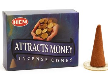 Kadzidełka stożkowe Attracts Money – stożek kadzidła na podstawce jako symbol przyciągania pieniędzy i dobrobytu. Opakowanie stożków zapachowych z napisem „Attracts Money” obok jednego stożka na podstawce.
